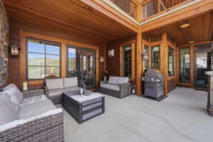 Sunroom / solarium featuring a balcony, a patio, and an outdoor hangout area