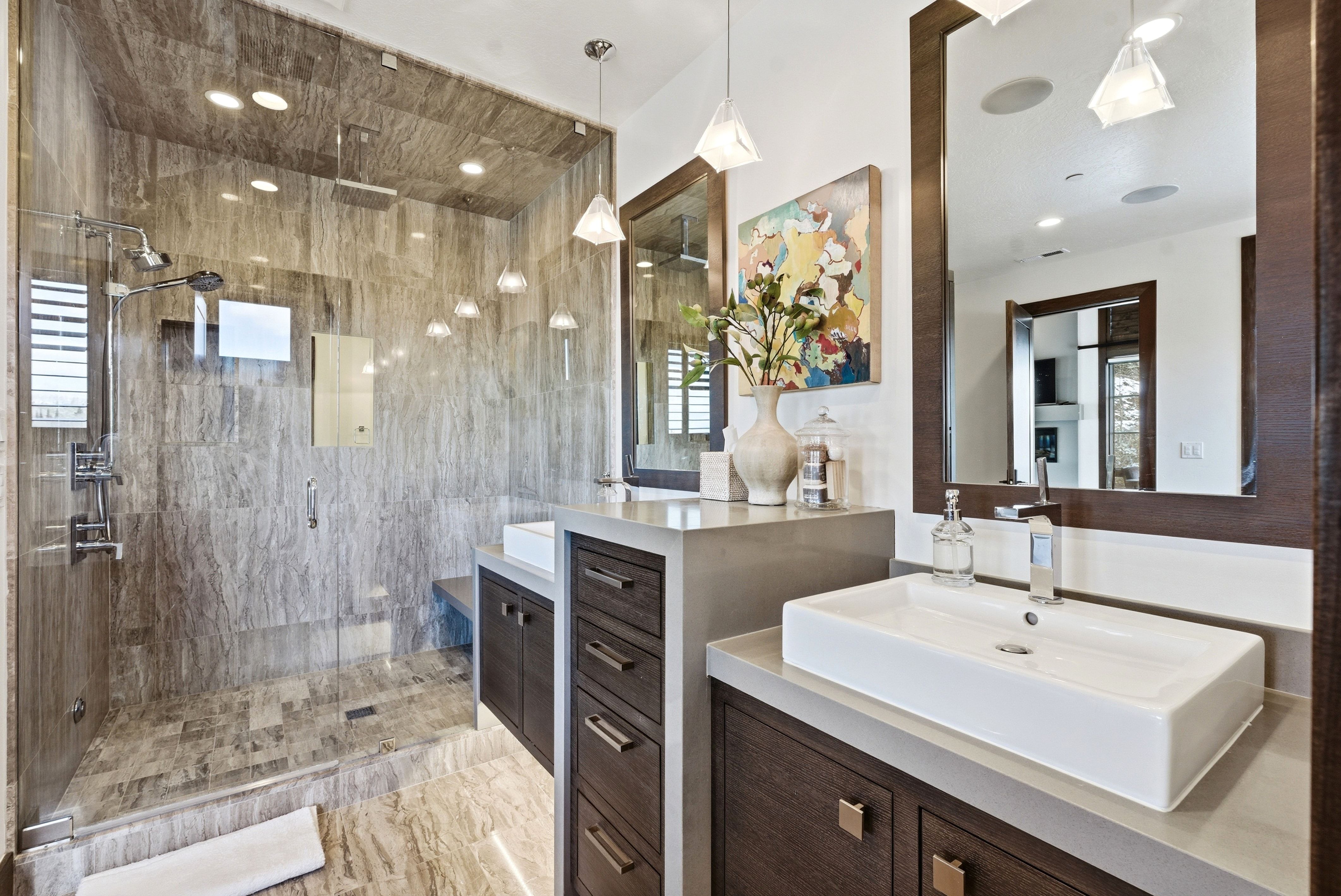 Bathroom with a shower stall and two vanities