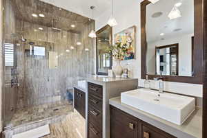 Bathroom with a shower stall and two vanities