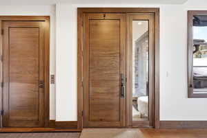 Foyer entrance featuring baseboards and wood finished floors