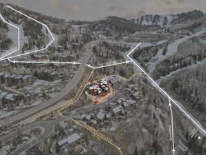 Snowy aerial view featuring a mountain view, property parcel outlined, and a residential view