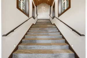 Stairs featuring wood ceiling