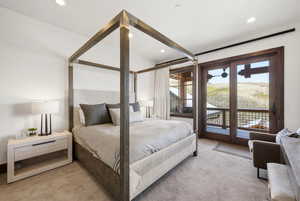 Bedroom with access to exterior, light carpet, and recessed lighting