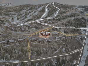 Snowy aerial view featuring property parcel outlined and a mountain view