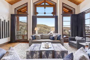 Living area featuring a vaulted wood ceiling, light wood-style floors, and plenty of natural light