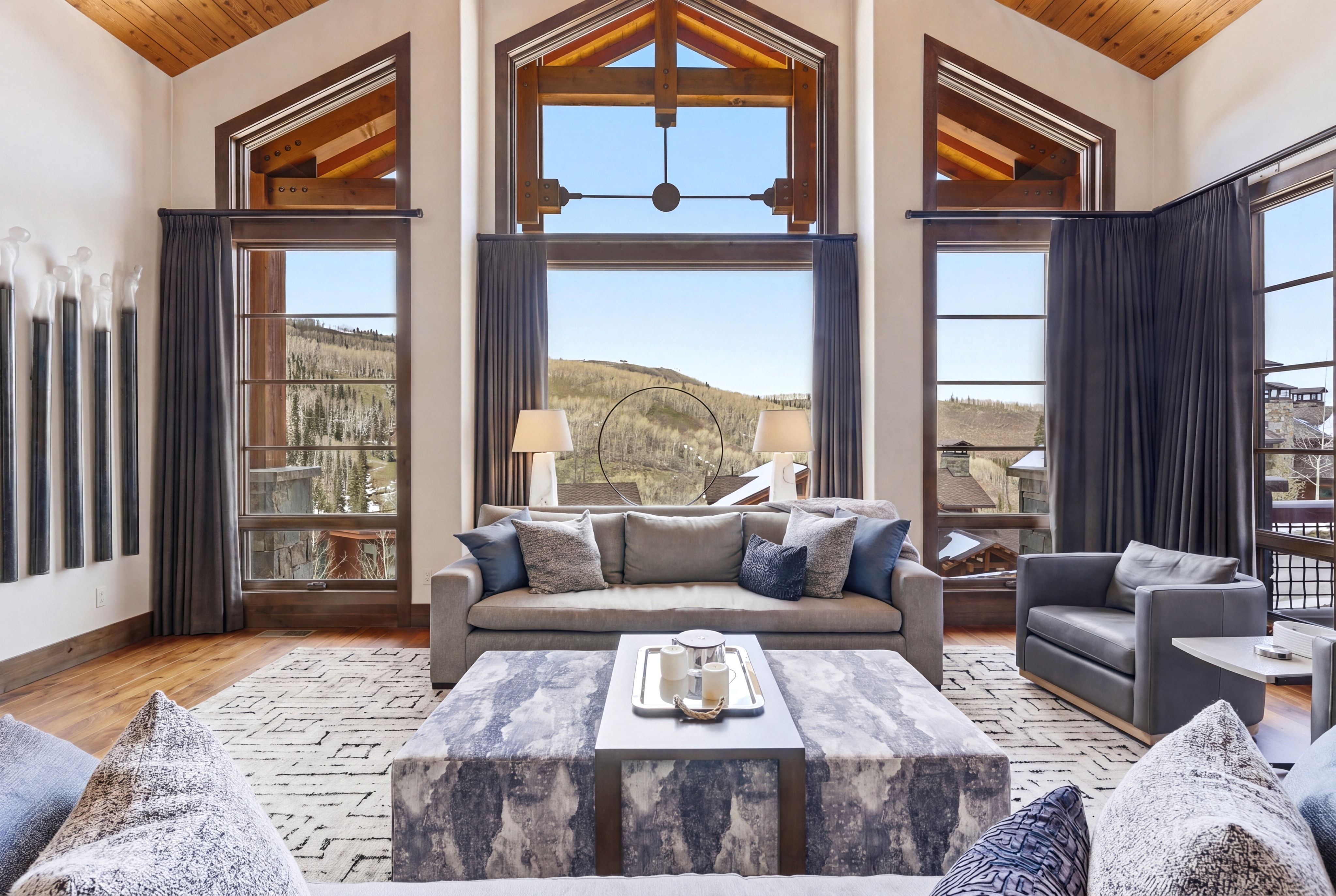 Living area featuring a vaulted wood ceiling, light wood-style flooring, and healthy amount of natural light