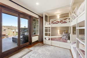 Bedroom with light wood-type flooring and access to outside