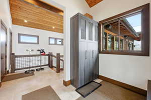 Foyer featuring wood ceiling and baseboards