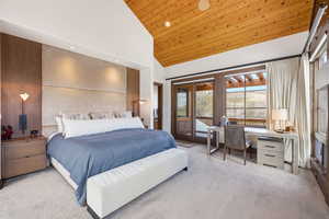 Bedroom with a vaulted wood ceiling, light carpet, an office area, recessed lighting, and access to outside