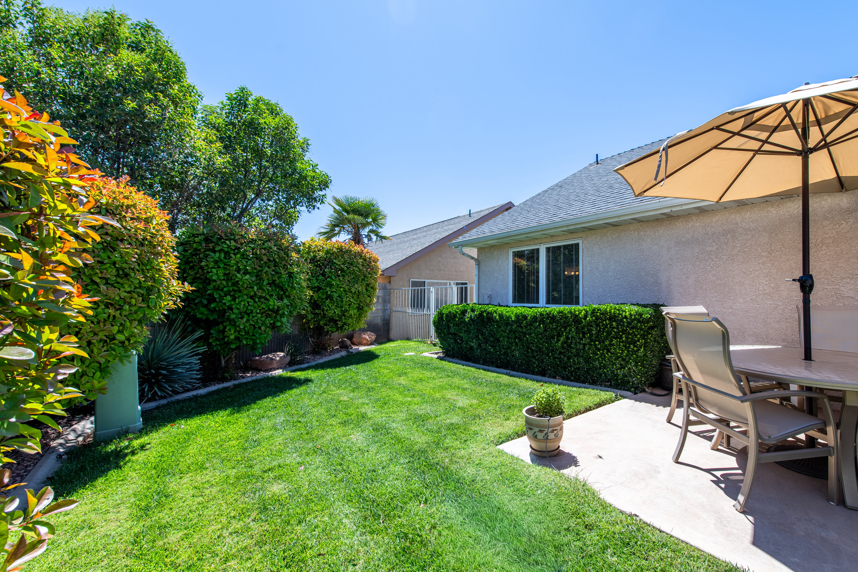 Fenced yard featuring outdoor dining space and a patio