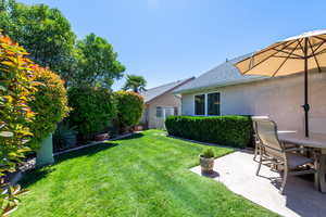 Fenced yard featuring outdoor dining space and a patio