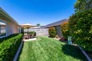 Fenced backyard with a patio area
