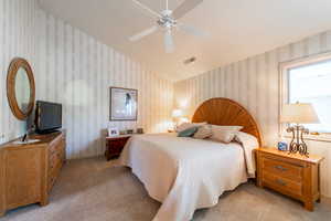 Bedroom with light carpet and ceiling fan