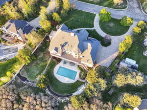 Aerial view of property and surrounding area featuring a pool