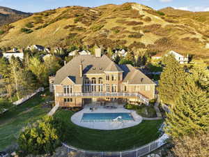 Drone / aerial view of a mountain backdrop and a pool area