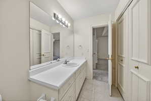 Bathroom featuring vanity and light tile floors
