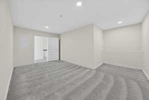 Bonus room featuring recessed lighting, light colored carpet, and electric panel