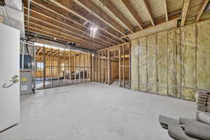 Basement room with concrete flooring and heating unit