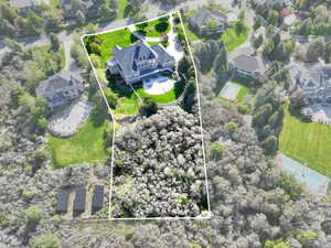 Aerial perspective of suburban area featuring property parcel outlined