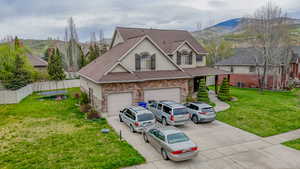 View of front of property featuring stucco siding, a trampoline, driveway, and stone siding