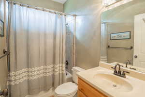 Full bathroom with shower / tub combo and vanity