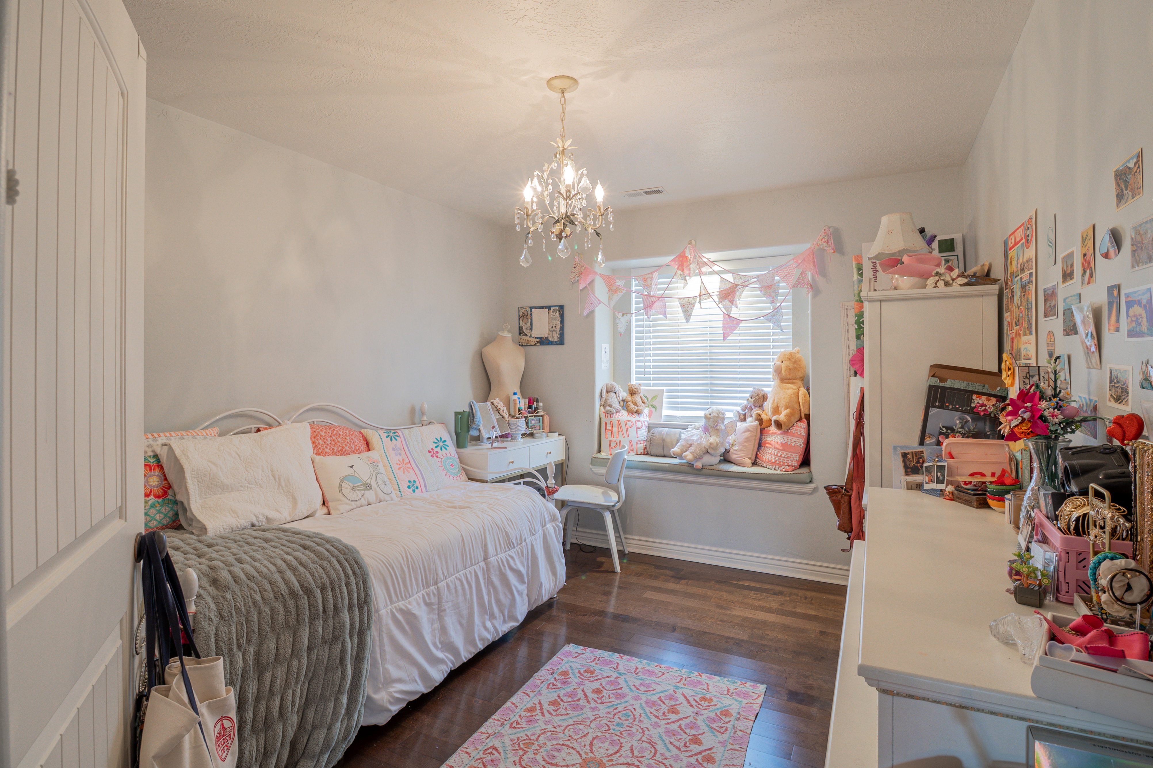 Bedroom featuring dark wood finished floors and a chandelier
