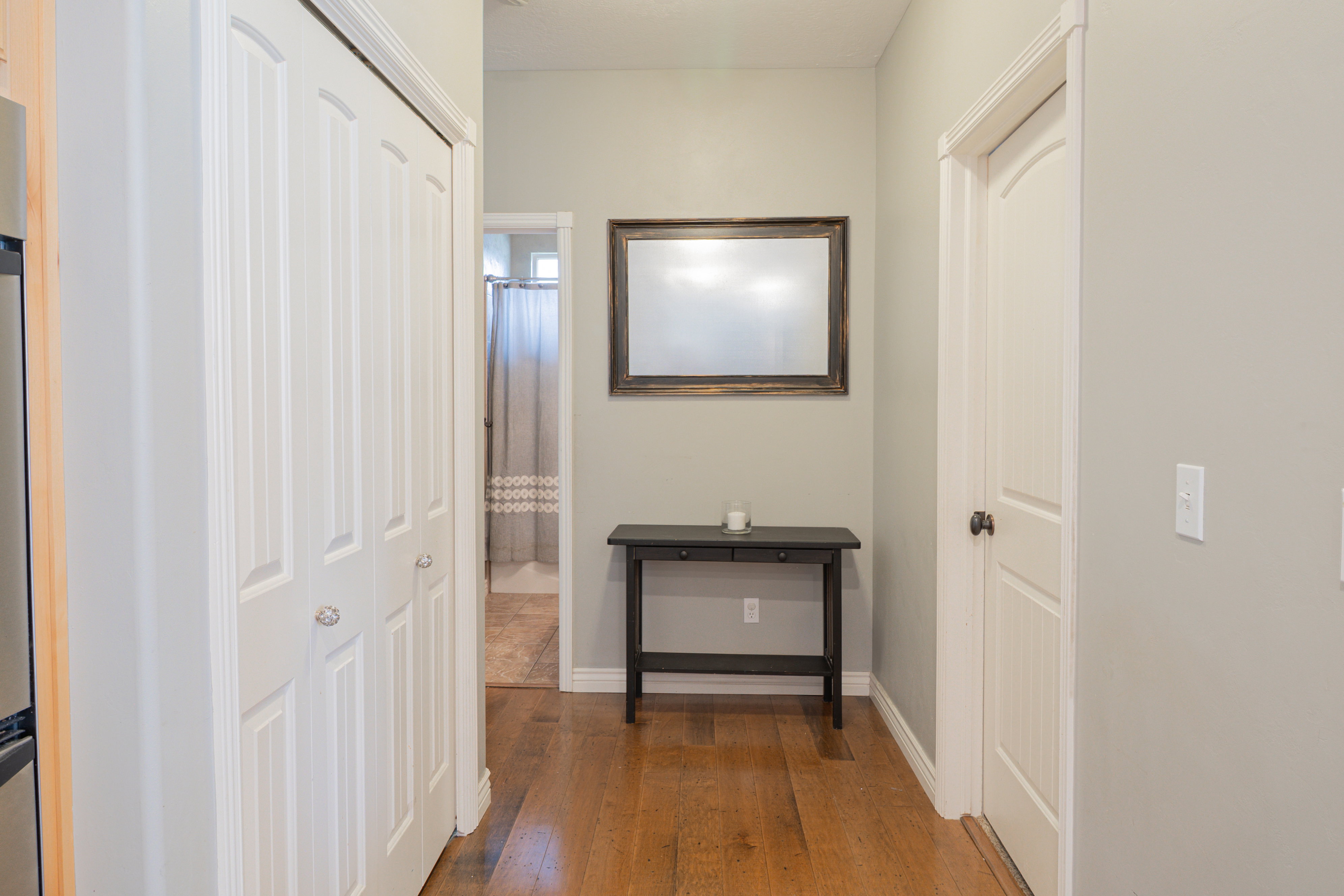 Hall with dark wood-style floors and baseboards