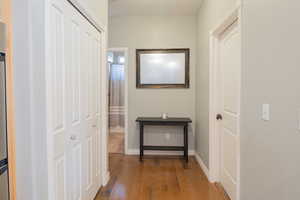 Hall with dark wood-style floors and baseboards