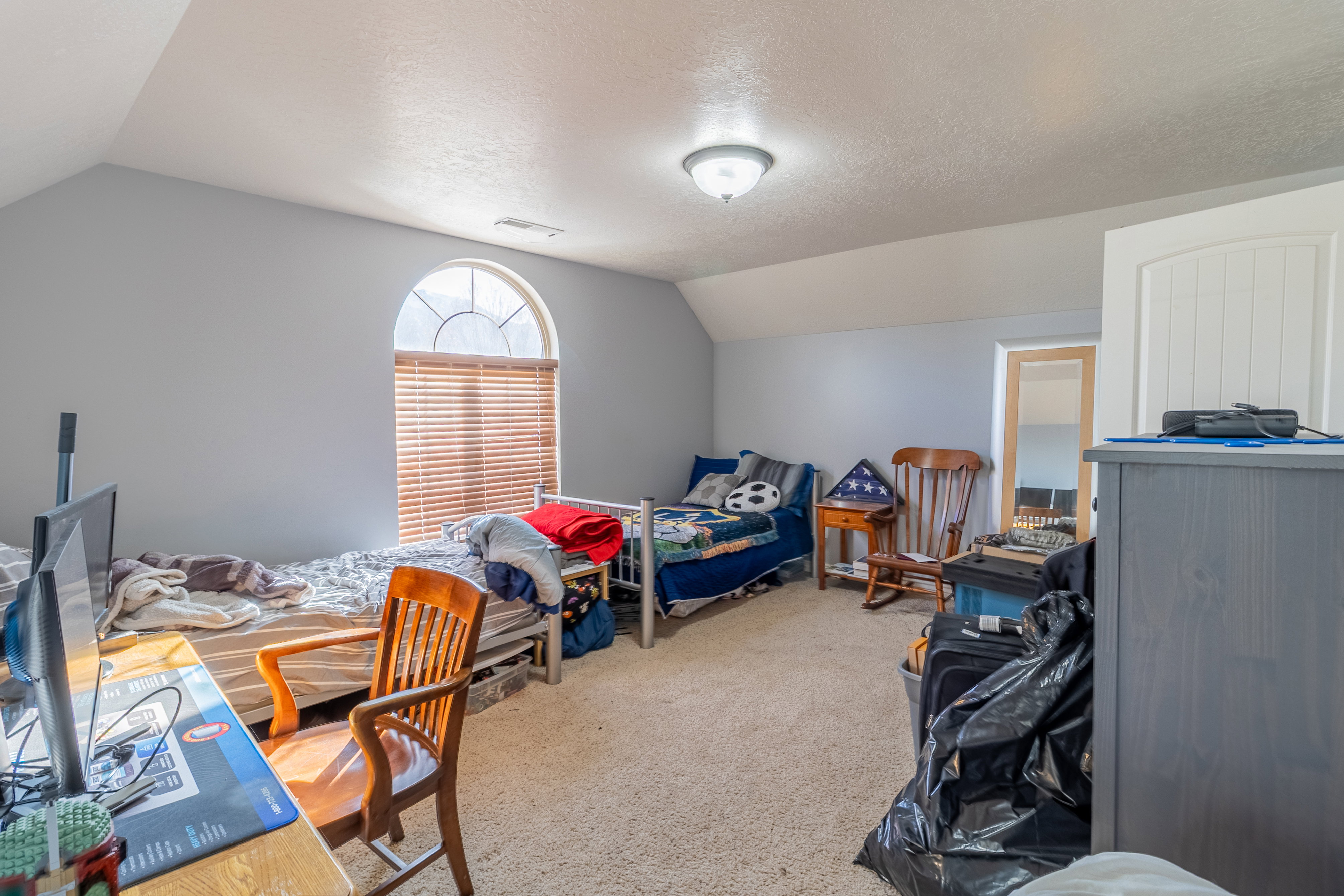Bedroom featuring light carpet