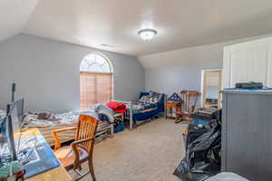 Bedroom featuring light carpet