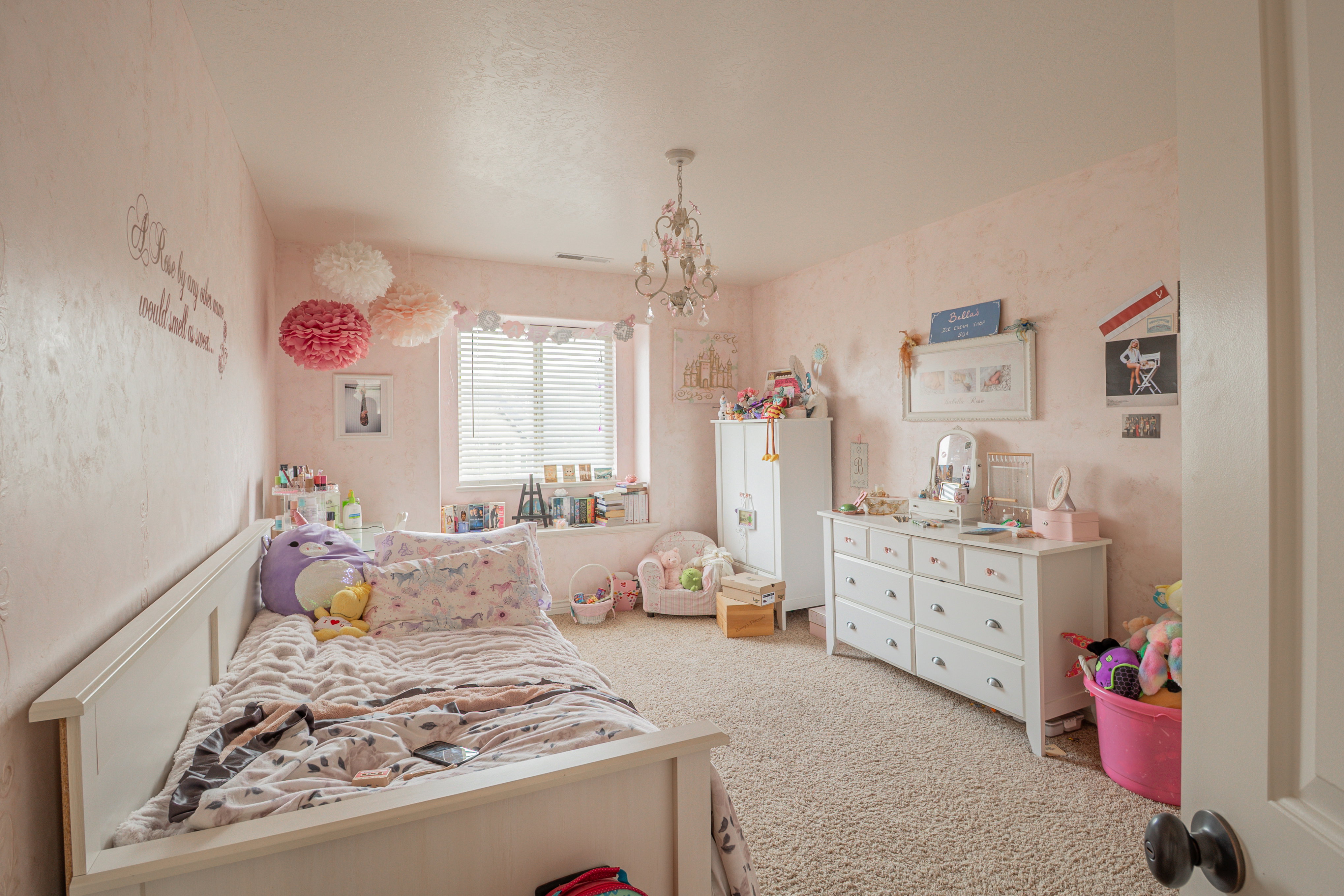 Bedroom featuring light carpet and hanging lights