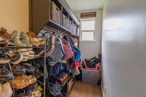 Walk in closet featuring light wood finished floors