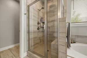 Primary bathroom, full bath with a bath, a stall shower, and light tile patterned flooring