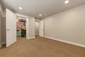 Bedroom 2 featuring light carpet, recessed lighting, and a spacious closet