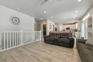 Living area featuring a ceiling fan and recessed lighting