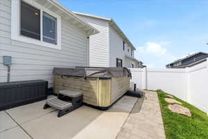 Fenced backyard with a hot tub