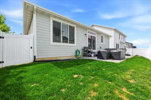 Back of house featuring a gate, a fenced backyard, a patio area, and an outdoor living space