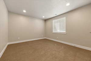 Bedroom 2 featuring light carpet, recessed lighting and a spacious closet
