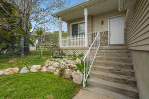 Doorway to property featuring a gate and covered porch