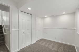 Basement featuring dark carpet and recessed lighting