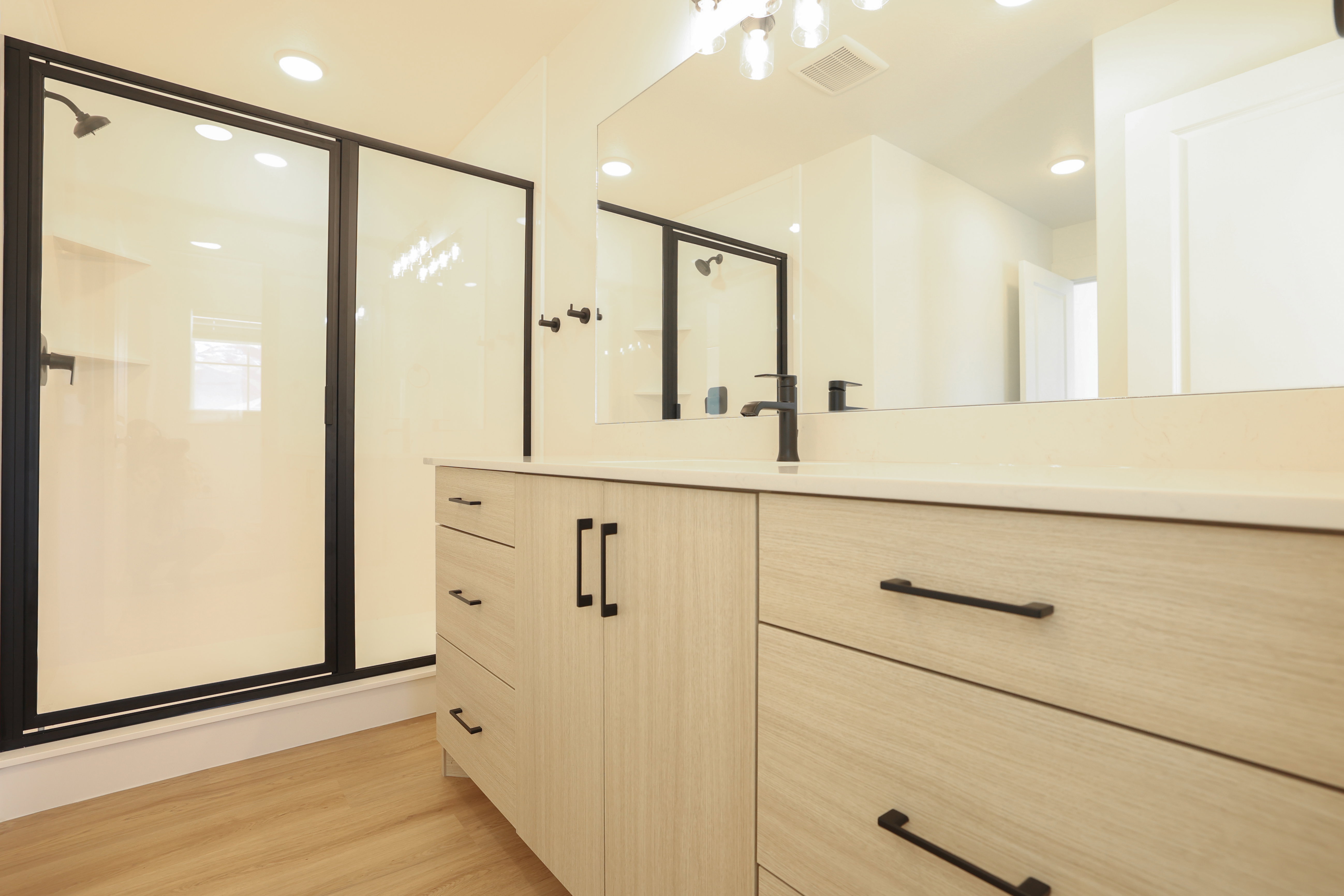 Bathroom featuring a stall shower, vanity, recessed lighting, and light wood-style flooring