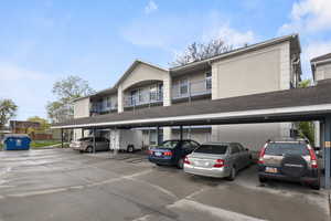View of building exterior featuring covered parking