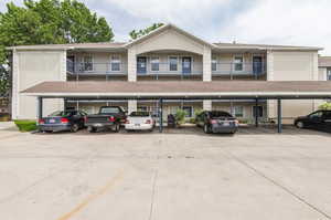 View of property featuring covered parking