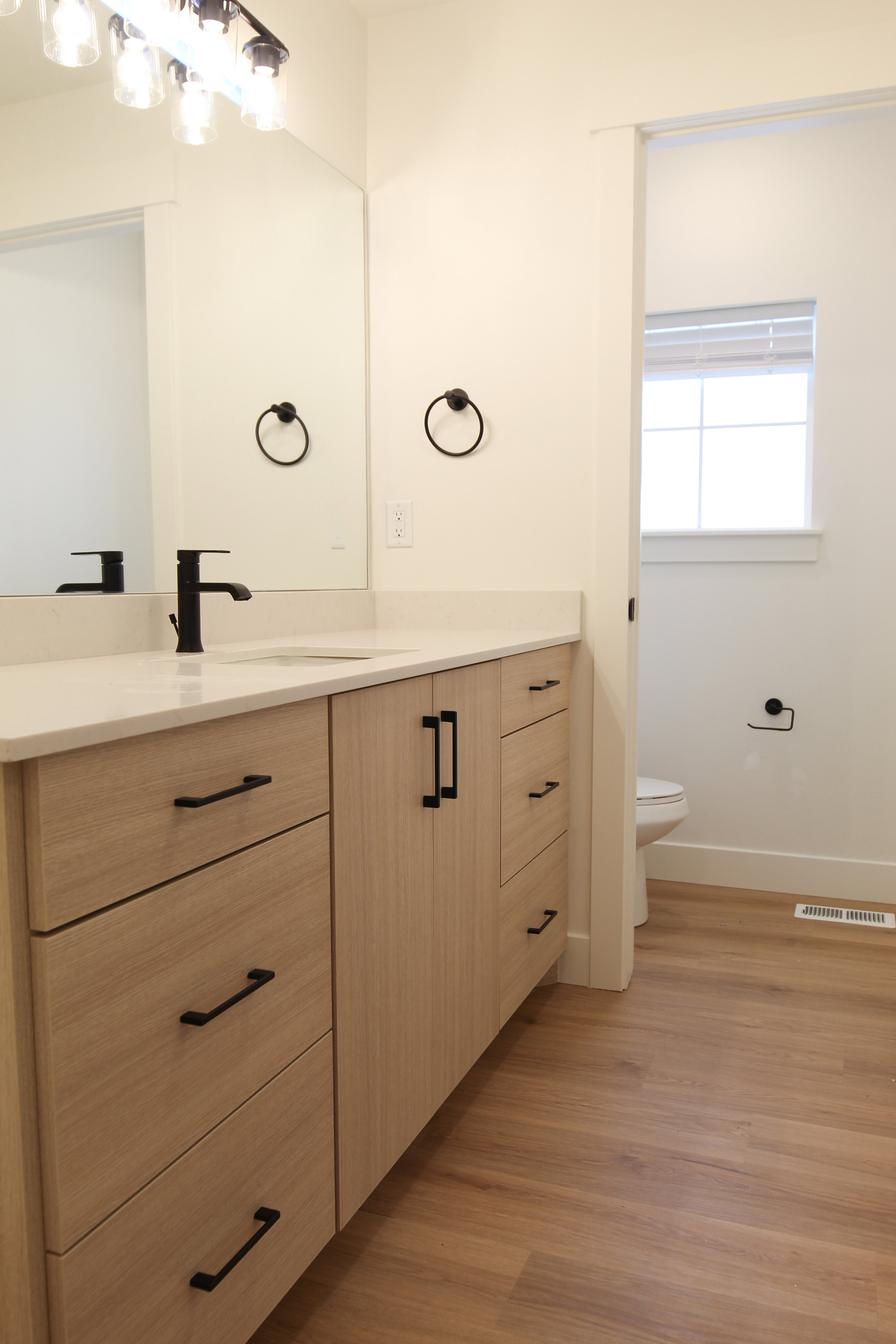 Bathroom with vanity and light wood finished floors