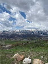 View of mountain backdrop featuring rural landscape