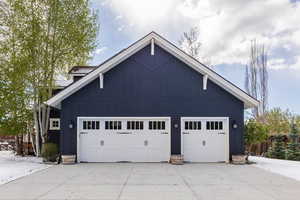 Garage featuring concrete driveway