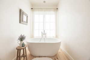 Full bathroom featuring baseboards and a soaking tub