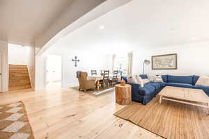 Living area with stairs and light wood-style floors