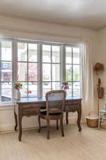 Office area featuring baseboards and light colored carpet