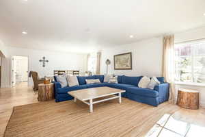 Living room featuring light wood-type flooring and recessed lighting